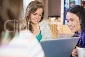 Young students doing assignment on laptop together