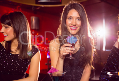 Pretty brunette drinking a cocktail