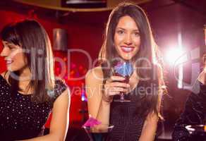 Pretty brunette drinking a cocktail