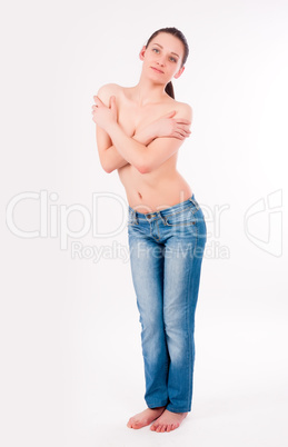 topless woman in jeans covering her breasts