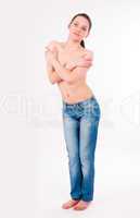 topless woman in jeans covering her breasts