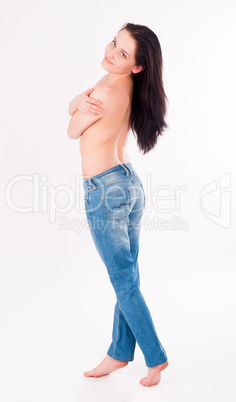 topless woman in jeans covering her breasts