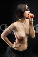 Topless woman offers apple