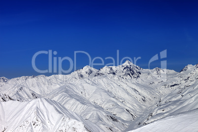 Snowy mountain peaks in sun day