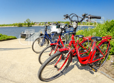 Colourful bikes parked along the river