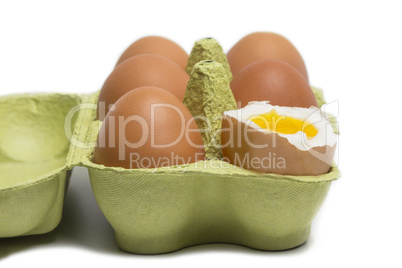 Box of Eggs with one broken boiled egg