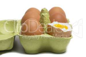 Box of Eggs with one broken boiled egg