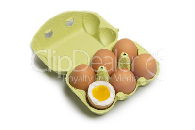 Box of Eggs with one broken boiled egg