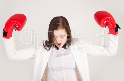 Angry businesswoman in boxing gloves