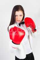 young businesswoman in boxing gloves