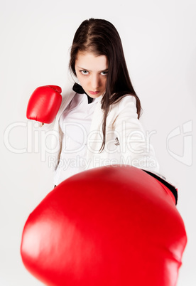 young businesswoman in boxing gloves