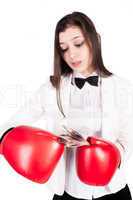 young businesswoman in boxing gloves with cash
