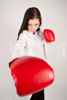 young businesswoman in boxing gloves