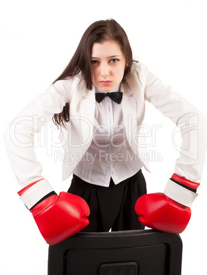 Young angry businesswoman in boxing gloves