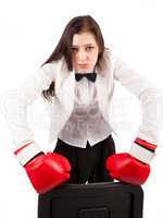 Young angry businesswoman in boxing gloves