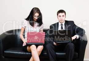 Businessmen with laptops on sofa