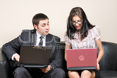 Businessmen with laptops on sofa