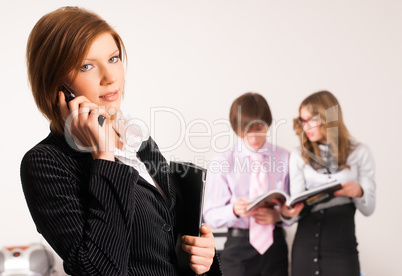 Businesswoman calling by phone in office