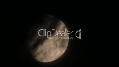 Dark night clouds on background moon disk