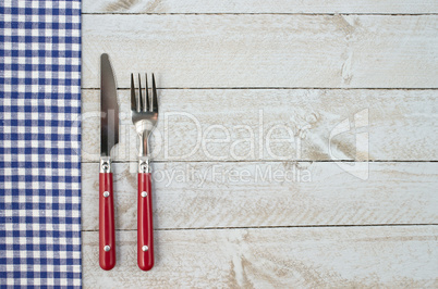 Fork and knife on wooden background