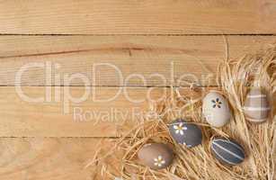 Easter nest with eggs on wooden background