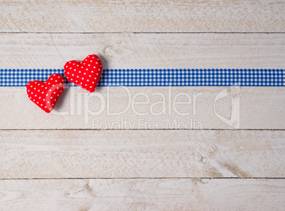 Two red Hearts on wooden Background