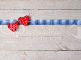 Two red Hearts on wooden Background