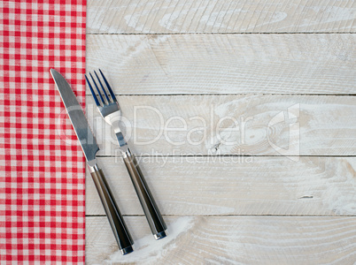 Fork and knife on wooden background