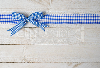 Blue ribbon on wooden background