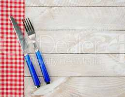 Fork and knife on wooden background