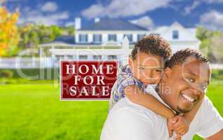 Father and Son In Front of Sale Sign and House
