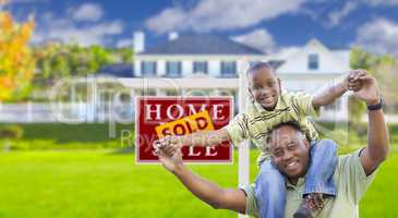 Father and Son In Front of Real Estate Sign and Home