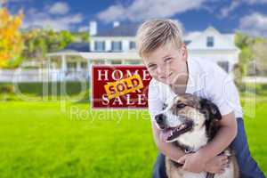 Boy and His Dog in Front of Sold Sign, House