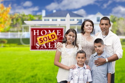 Hispanic Family in Front of Sold Real Estate Sign, House