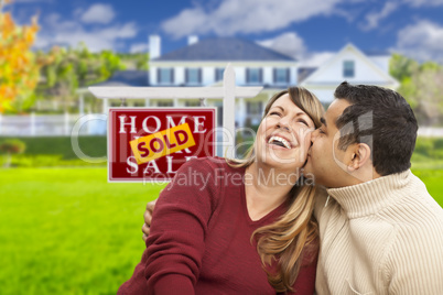 Mixed Race Couple in Front of Sold Real Estate Sign