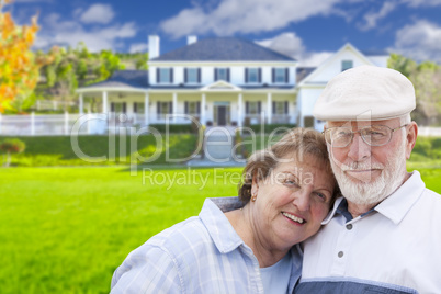 Happy Senior Couple in Front of House