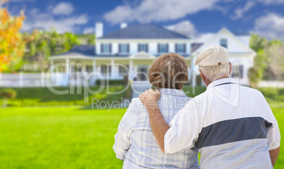 Happy Senior Couple Looking at Front of House