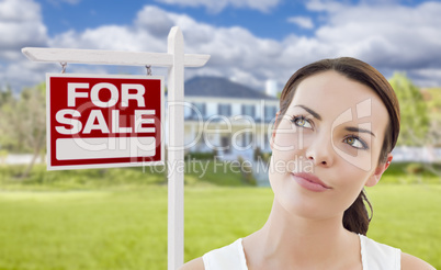 Thinking Woman In Front of House and For Sale Sign