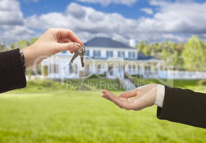 Agent Handing Over House Keys in Front of New Home