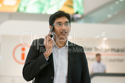 Businessman walking by information counter