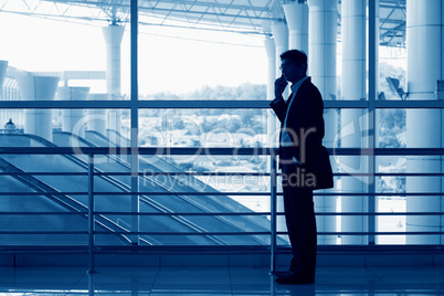Silhouette of Indian man on mobile phone