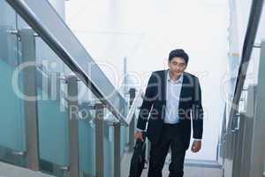 Asian Indian businessman ascending steps