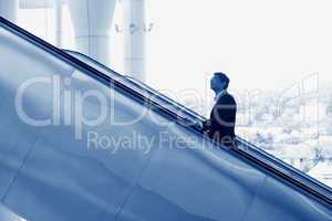 Indian businessman going up escalator