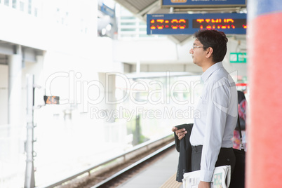 Indian businessman waiting train