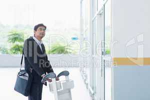 Indian businessman with airport trolley