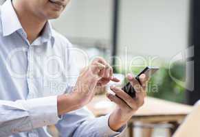 Indian businessman using smartphone while having lunch