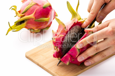 Opening A Ripe Dragonfruit With A Longitudinal Cut