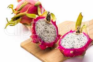 Two Pitaya Halves And A Whole Dragonfruit