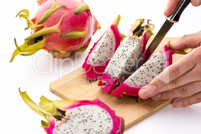 Cutting Off A Second Fruit Chip From A Pitaya Half