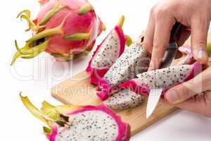 Chef?s Hands Detaching Pulp From A Pitaya Wedge
